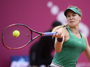 Eugenie Bouchard returns a ball to Alize Cornet during their semifinal game at the WTA Ladies Championship tennis tournament in Gstaad, Switzerland, Saturday, July 21, 2018. (Anthony Anex/Keystone via AP)