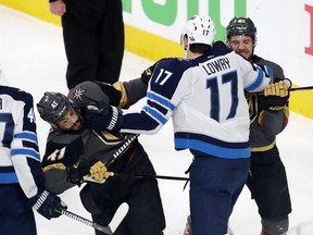 LAS VEGAS, NV - MAY 16: Adam Lowry #17 of the Winnipeg Jets mixes it up with Pierre-Edouard Bellemare #41 and Shea Theodore #27 of the Vegas Golden Knights after the whistle during the third period in Game Three of the Western Conference Finals during the 2018 NHL Stanley Cup Playoffs at T-Mobile Arena on May 16, 2018 in Las Vegas, Nevada. (Photo by Isaac Brekken/Getty Images)
