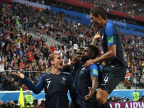 Samuel Umtiti of France celebrates with teammates after scoring his team's first goal during the 2018 FIFA World Cup Russia Semi Final match between Belgium and France at Saint Petersburg Stadium on July 10, 2018 in Saint Petersburg, Russia. (Shaun Botterill/Getty Images)