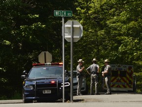 New York State Police block the entrance of Welch Road in Corning, N.Y., Monday, July 2, 2018, as they investigate the scene of a shooting in nearby Erwin.