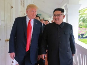 U.S. President Donald Trump (L) and North Korea's leader Kim Jong Un (R) walk after a meeting during their historic US-North Korea summit, at the Capella Hotel on Sentosa island in Singapore on June 13, 2018. (Getty Images)