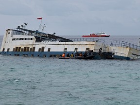 Members of a rescue team continue to search and examine a ferry which ran aground on July 3 off the coast of Selayar island in South Sulawesi on July 5, 2018. (YUSUF WAHIL/AFP/Getty Images)