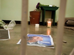 In this file photo taken on December 13, 2013, a candle burns in the former cell of Nelson Mandela during a visit of a group of activists, religious leaders and former prisoners (unseen) at Robben Island, Cape Town, for an all night vigil to commemorate Nelson Mandela, who was a prisoner on the island during the Apartheid era. (RODGER BOSCH/AFP/Getty Images)