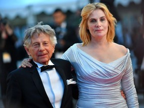 (FILES) In this file photo taken on May 27, 2017 French-Polish director Roman Polanski (L) and French actress Emmanuelle Seigner leave the Festival Palace following the screening of the film 'Based on a True Story' (D'Apres une Histoire Vraie) at the 70th edition of the Cannes Film Festival in Cannes, southern France.  The wife of Roman Polanski, French actress Emmanuelle Seigner, said Sunday she had rejected an invitation to join the body that awards the Oscars in protest at its decision to expel her husband over his historic statutory rape conviction in the US.