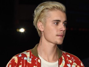 Justin Bieber attends the Yves Saint Laurent men's fall line and the first part of its women's collection fashion show at the Paladium, in Hollywood, California on Feb. 10, 2016. (Robyn Beck/Getty Images)