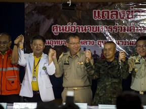Chiang Rai Governor Narongsak Osotthanakorn (C) and mission team celebrate after a press conference at a makeshift press centre in Mae Sai district of Chiang Rai province on July 11, 2018. (Ye Aung Thu/Getty Images)