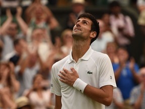 Serbia's Novak Djokovic reacts after winning against Spain's Rafael Nadal during the continuation of their men's singles semi-final match on the twelfth day of the 2018 Wimbledon Championships at The All England Lawn Tennis Club in Wimbledon, southwest London, on July 14, 2018. Djokovic won the match 6-4, 3-6, 7-6, 3-6, 10-8.