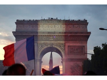 People celebrate after the Russia 2018 World Cup final football match between France and Croatia, near the Arch of Triumph on the Champs-Elysees avenue in Paris on July 15, 2018.