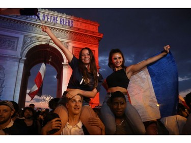 People celebrate after the Russia 2018 World Cup final football match between France and Croatia, near the Arch of Triumph on the Champs-Elysees avenue in Paris on July 15, 2018.