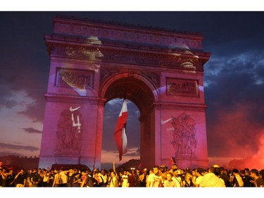 People celebrate after the Russia 2018 World Cup final football match between France and Croatia, near the Arch of Triumph on the Champs-Elysees avenue in Paris on July 15, 2018.