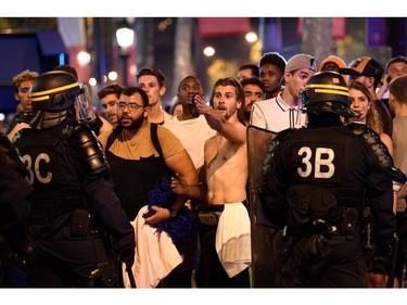 Police dispers people after celebrations following the Russia 2018 World Cup final football match between France and Croatia, on the Champs-Elysees avenue in Paris on July 15, 2018.  France won 4-2.