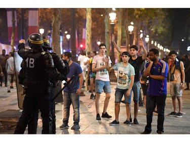 Police dispers people after celebrations following the Russia 2018 World Cup final football match between France and Croatia, on the Champs-Elysees avenue in Paris on July 15, 2018.  France won 4-2.