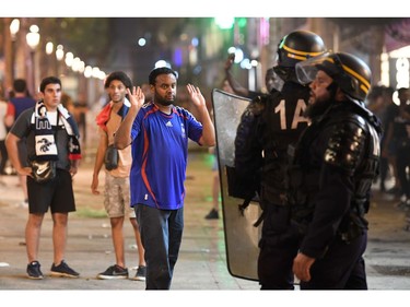 Police dispers people after celebrations following the Russia 2018 World Cup final football match between France and Croatia, on the Champs-Elysees avenue in Paris on July 15, 2018.  France won 4-2.