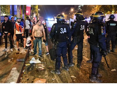 Police dispers people after celebrations following the Russia 2018 World Cup final football match between France and Croatia, on the Champs-Elysees avenue in Paris on July 15, 2018.  France won 4-2.