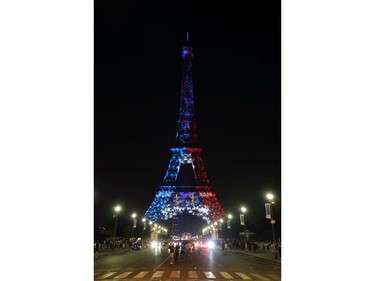 The Eiffel Tower illuminated in French national colors is seen during celebrations after the Russia 2018 World Cup final football match between France and Croatia, on the Champs-Elysees avenue in Paris on July 15, 2018. France beat Croatia 4-2.