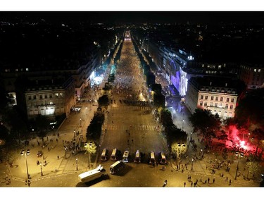 This picture taken from the top of the Arch of Triumph (Arc de Triomphe) on July 15, 2018 shows security forces working to contain clashes following celebrations of the Russia 2018 World Cup final football match between France and Croatia, on the Champs-Elysees avenue in Paris.