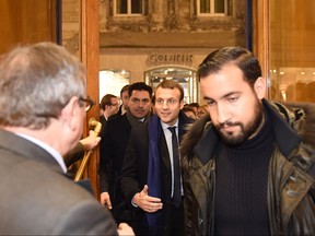 In this file photo taken on December 13, 2016 Emmanuel Macron (centre), head of "En Marche" political movement and presidential candidate, arrives, flanked by his bodyguard Alexandre Benalla (right), in a library, on December 13, 2016, before a book signing session as part of his campaign. (NICOLAS TUCAT/AFP/Getty Images)