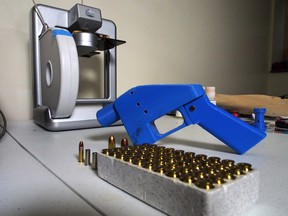 In this file photo taken on July 17, 2013 a Liberator pistol appears  next to the 3D printer on which its components were made in Hanover, Maryland. 
(ROBERT MACPHERSON/AFP/Getty Images)