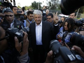 Mexican presidential candidate Andres Manuel Lopez Obrador, of the MORENA party, flashes the victory sign as he arrives to vote at a polling station during general elections in Mexico City, Mexico, Sunday, July 1, 2018.
