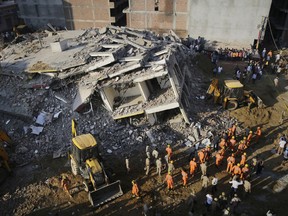 Rescuers work at the site of a collapsed building in Shahberi village, east of New Delhi, India, Wednesday, July 18, 2018. 
(AP Photo/Altaf Qadri)