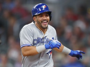 Toronto Blue Jays' Devon Travis celebrates hitting a grand slam against the Atlanta Braves. (AP Photo/Todd Kirkland)