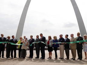 In this July 3, 2018, file photo, Susan Saarinen, daughter of Gateway Arch architect Eero Saarinen, cuts the ribbon dedicating the renovation to the newly renamed Gateway Arch National Park in St. Louis.  (AP Photo/Jeff Roberson, File)