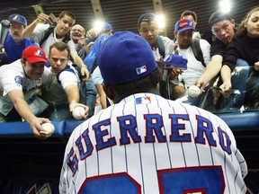 On Sunday, Vladimir Guerrero will become the first position player from the Dominican Republic inducted into the National Baseball Hall of Fame, and only the third player from that country to make the exclusive club, behind pitchers Juan Marichal and Pedro Martinez. Montreal Expos right fielder Vladimir Guerrero signs autographs before the team's final home game of the season against the Atlanta Braves in Montreal Wednesday, Sept. 17, 2003.