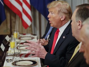 U.S. President Donald Trump gestures while speaking to NATO Secretary General Jens Stoltenberg during their bilateral breakfast, Wednesday, July 11, 2018 in Brussels, Belgium. (AP Photo/Pablo Martinez Monsivais)
