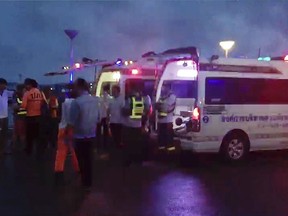 In this image made from video, ambulances line on a pier waiting for rescued tourists from a boat that sank, Thursday, July 5, 2018, off Phuket, southern Thailand. A boat carrying dozens of Chinese tourists overturned in rough seas off southern Thailand and dozens of passengers were unaccounted for, the Phuket governor said. (AP Photo)