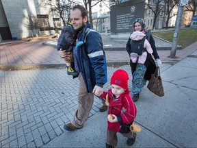 Joshua Boyle, his wife, Caitlan Boyle and their three children are seen strolling up Elgin St. past the court house in Ottawa on Nov. 22, 2017.