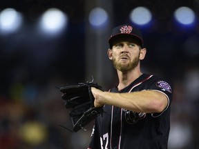 Washington Nationals starting pitcher Stephen Strasburg pauses between throws during a game against the Atlanta Braves at Nationals Park in Washington, Friday, July 20, 2018.