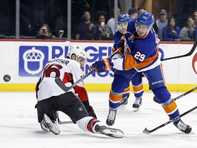 New York Islanders centre Brock Nelson (29) takes a shot on net past Ottawa Senators left wing Clarke MacArthur (16) Sunday, April 9, 2017, in New York. (AP Photo/Adam Hunger)