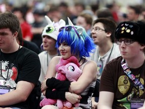 FILE - In this June, 30, 2012, file photo, My Little Pony cartoon fans, some in Little Pony costumes, listen to a presentation at "BronyCon" in Secaucus, N.J. The organizers of a "My Little Pony" convention say next year will be their last, citing declining fandom activity among "bronies." The Baltimore Sun reported BronyCon 2019 at the Baltimore Convention Center will be the convention's longest yet, from Aug. 1-4 next year.