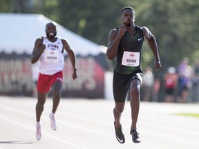 Aaron Brown competes in the final of the 200 metres, beside Oluwasegun Makinde, (left), during the Canadian track and field championships in Ottawa on Saturday, July 7, 2018.