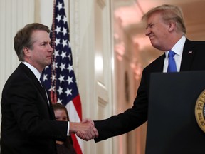 U.S. President Donald Trump shakes hands with Judge Brett Kavanaugh his Supreme Court nominee, in the East Room of the White House, Monday, July 9, 2018, in Washington.  (AP Photo/Alex Brandon)