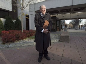 Bruce Carson stops as his lawyer speaks with journalists outside the courthouse, Tuesday, November 17, 2015 in Ottawa. (THE CANADIAN PRESS/Adrian Wyld)