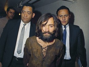 In this 1969 file photo, Charles Manson is escorted to his arraignment on conspiracy-murder charges in connection with the Sharon Tate murder case.