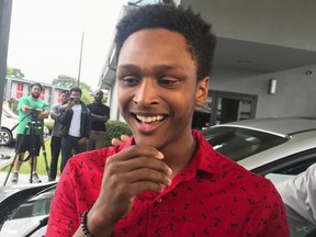 Alabama college student Walter Carr reacts after being given a new car by Bellhops CEO Luke Marklin in Pelham, Ala., Monday, July 16, 2018. (Carol Robinson/The Birmingham News via AP)