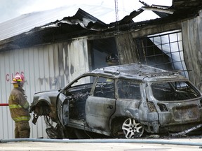 In this Thursday, July 5, 2018 photo, firefighters work to put out a fire at Pikel's Top Tier Fuels in Rayne, Pa. Authorities say a drunk driver crashed into a pump at the Pennsylvania gas station, sparking a fire that killed an employee who became trapped inside the burning service station building. (Bruce Siskawicz/The Indiana Gazette via AP)