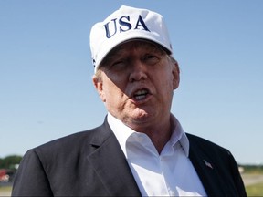 U.S. President Donald Trump speaks to media before boarding Air Force One at Morristown Municipal Airport, in Morristown, N.J., Sunday, July 8, 2018, en route to Washington from Trump National Golf Club in Bedminster, N.J.