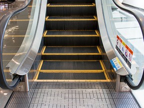 Close up modern escalator in shopping center. Moving up staircase.