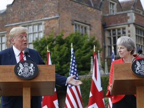 President Donald Trump with British Prime Minister Theresa May during their joint news conference at Chequers, in Buckinghamshire, England, Friday, July 13, 2018.