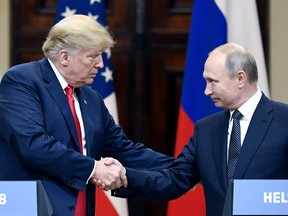 U.S. President Donald Trump and Russian President Vladimir Putin shake hands during a join press conference at the Presidential Palace in Helsinki, Finland, Monday, July 16, 2018. (Jussi Nukari/Lehtikuva via AP)