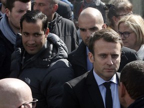 In this April 26, 2017 file photo, Emmanuel Macron, right, is flanked by his bodyguard, Alexandre Benalla, left, in Amiens, France.