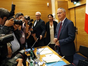 Elysee Chief of Staff Patrick Strzoda, right, arrives for a hearing with the deputies of the Laws Commission concerning the case of President Macron's security aide Alexandre Benalla, at the National Assembly in Paris, France, Tuesday, July 24, 2018.