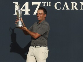 Francesco Molinari holds the trophy after winning the British Open in Carnoustie, Scotland, Sunday July 22, 2018.