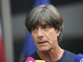 Head coach Joachim Löw answers questions after arriving at the airport in Frankfurt, Germany, Thursday, June 28, 2018, one day after the German team was eliminated from the soccer World Cup in Russia. (AP Photo/Ina Fassbender)