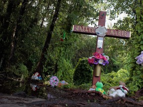 A cross is setup in the Caylee Anthony memorial that has been placed in the area where the 2-year-old child remains were found on July 16, 2011 in Orlando, Florida. (Joe Raedle/Getty Images)