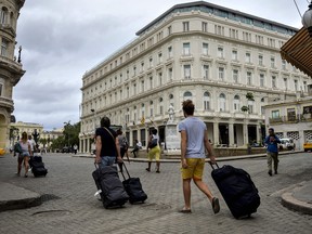 Tourists walk near the Manzana Kempinski Hotel in Havana on April 19, 2018, day in which Miguel Diaz-Canel was formally named Cuba's new president, and thus succeeding Raul Castro. (Yamil Lage/Getty Images)