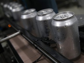 Freshly canned beers move on an assembly line at Devil's Canyon Brewery on June 6, 2018 in San Carlos, Calif. New tariffs imposed by U.S. president Donald Trump on aluminum from Canada, Mexico and the European Union could cause the price of canned beer and soft drinks to rise. (Justin Sullivan/Getty Images)